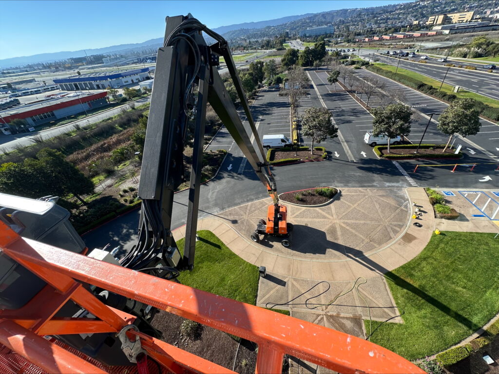 Professional building painting and exterior maintenance using boom lift equipment